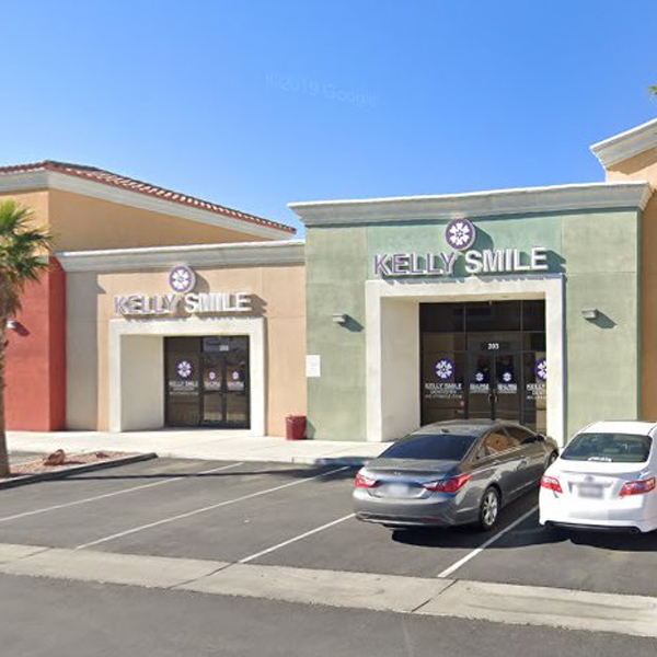 Kelly Smile Dentistry storefront in Victorville with parked cars and clear blue sky